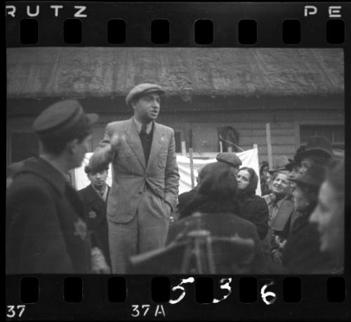 Man making an announcement to residents in the ghetto