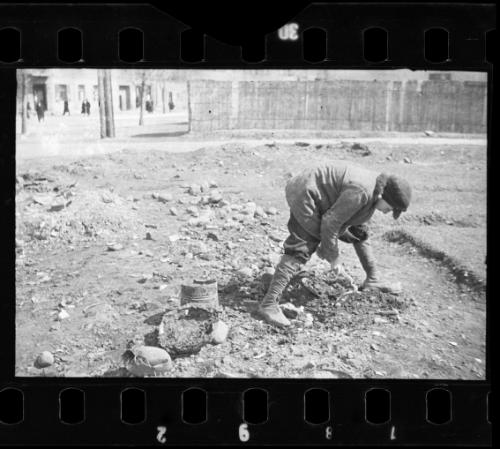 Boy digging for food in the ground