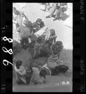 Residents sorting belongings left behind after deportation