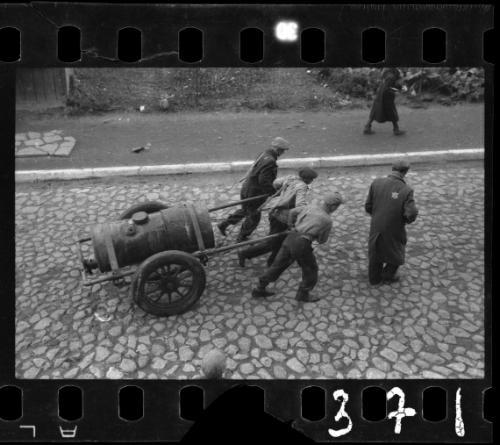 Men hauling a cart through the ghetto