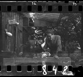 Portrait of two men with a rabbit