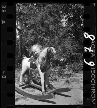 A child with a rocking horse