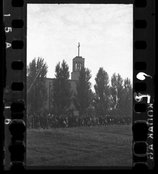 Massive deportation of residents from the Lodz ghetto walking by a church