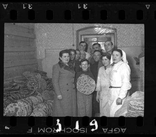Residents with matzo in the bakery