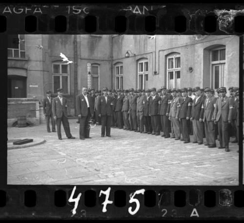 Jewish policemen standing in a line in a courtyard