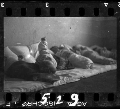 Babies lying on floor mat, probably in the hospital nursery