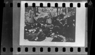 "Under the eye of Nazi soldiers, and before their own execution: doomed Poles dig their own graves and those of others already murdered."