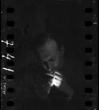 Portrait of a man lighting a cigarette