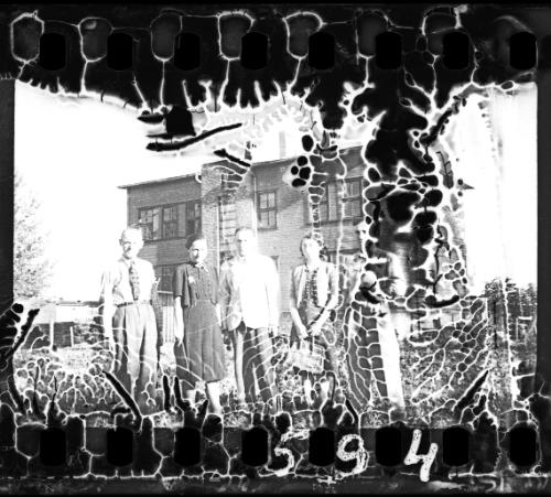 Ghetto residents in front of a three-storey building