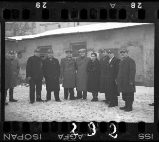 Workers of the Transport Department standing outside of a building in the winter