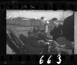 Men and woman in a carriage in the ghetto