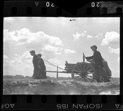Residents pulling a hearse through the ghetto