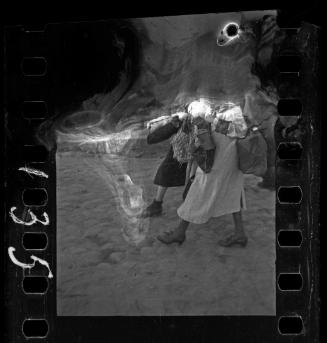 Residents being deported from the ghetto, walking with their belongings