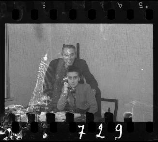 Man and woman at desk with telephone