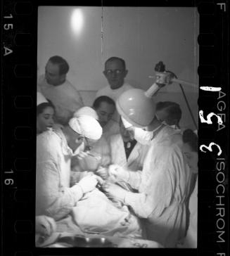 Doctors performing surgery on baby
