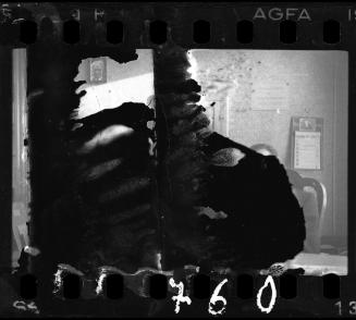 An office with a portrait of Mordechai Chaim Rumkowski on the wall and a calendar with Mordechai Chaim Rumkowski's portrait