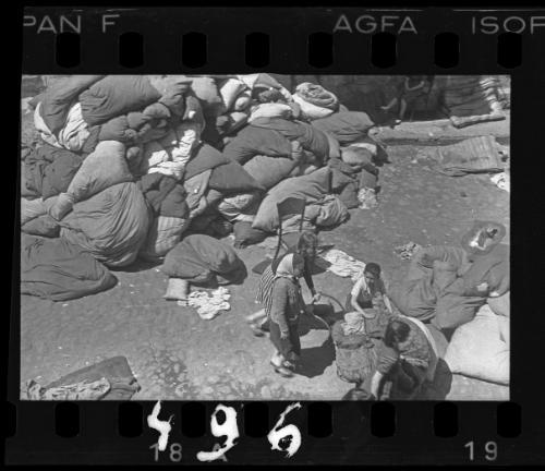 Residents sorting belongings left behind after deportation