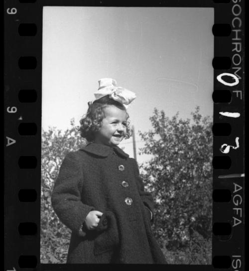 A young girl with a large bow in her hair, before 1942