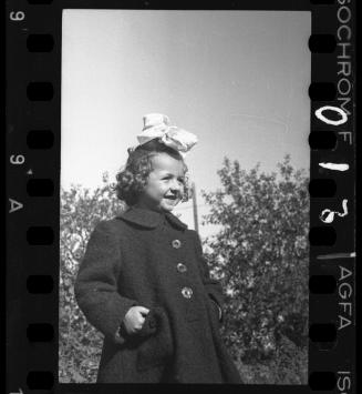 A young girl with a large bow in her hair, before 1942
