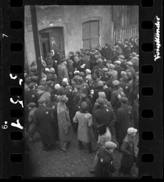 Residents gathered outside the doorway of building #44 in the ghetto