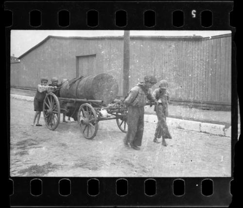 Workers pulling fecal wagon