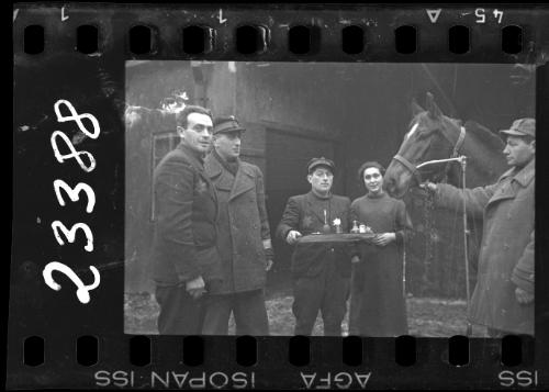 Workers of the Transport Department standing with a horse in the ghetto