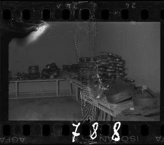 Violins and cellos in a storeroom, probably confiscated by the administration