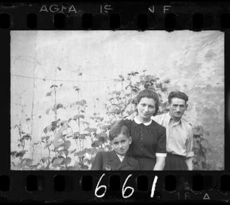 Family with a boy against vines