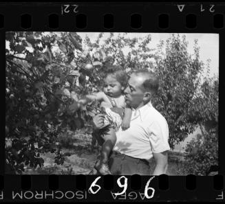 A man holding a baby in his arms