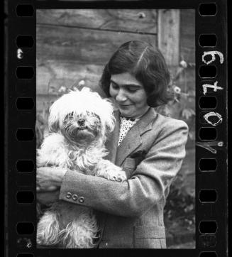 Female ghetto resident holding a small dog