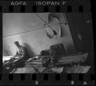 Young man with his head down on his desk