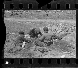 Children searching for food buried in the ground