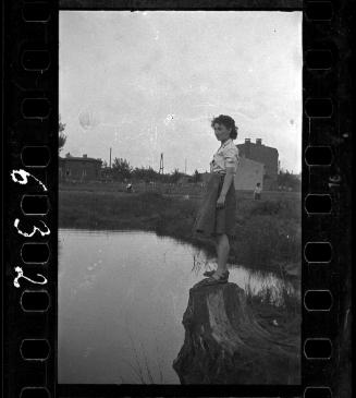 Young girl on a tree stump