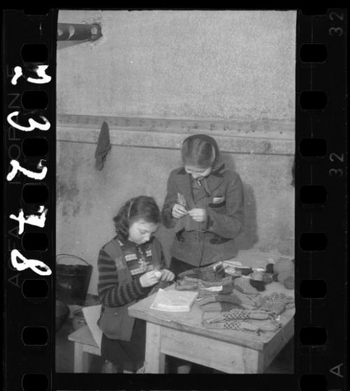 Two young girls knitting