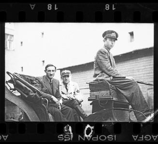 Ghetto official and policeman riding in carriage