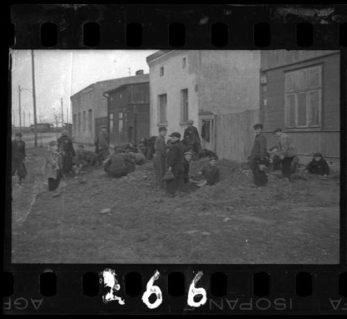 Men and children digging for food, coal and other provisions