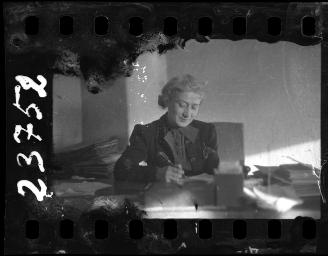 Woman writing at her desk