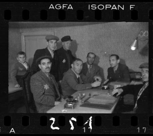 Group of eight men working at a table