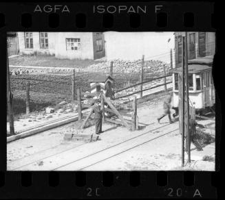 Jewish policeman standing at an entry gate to the ghetto