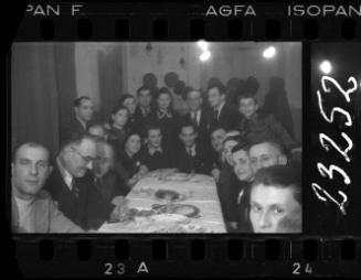 Large group of residents gathered around a dinner table