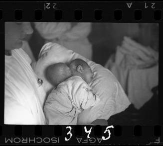 Nurse holding baby before surgery