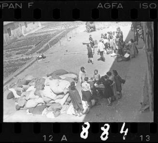 Residents sorting belongings left behind after deportation
