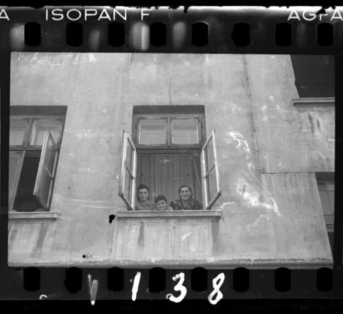 Two women and a boy looking out the window