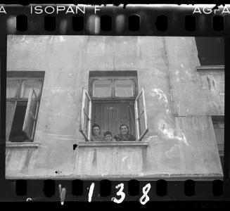 Two women and a boy looking out the window