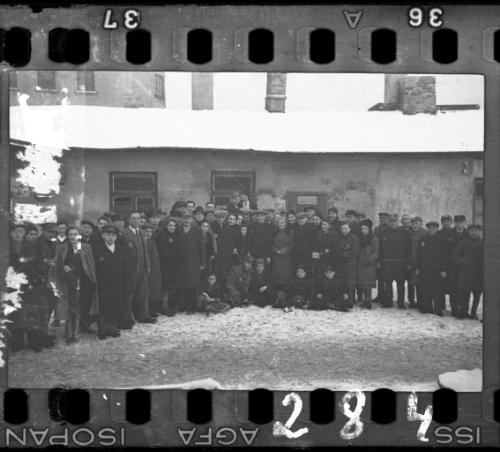 Large group of men and women workers and administrators of the Transport Department in the ghetto in winter