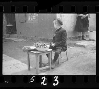Young boy selling foodstuff in the street