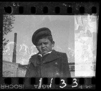 Portrait of a boy in a coat and a hat