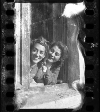 Stefania Schoenberg (left) and Inka Z. smiling in an open window