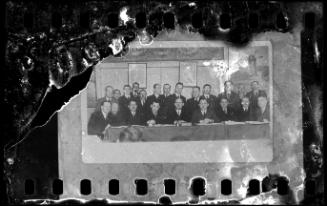 Group portrait of men around a table