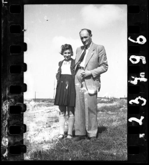 Father and a daughter posing in the open field